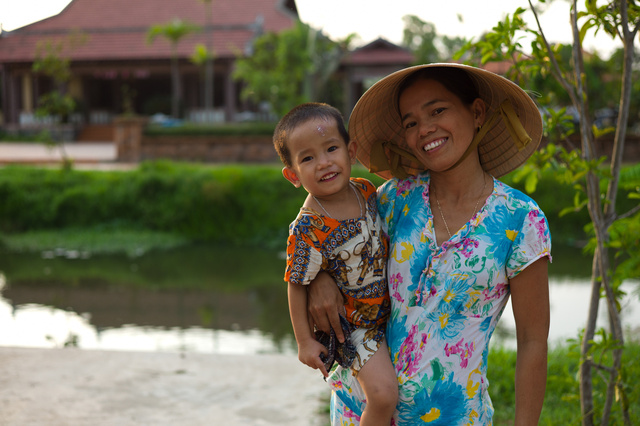 Young woman and child at the Japanese bridge, Hue