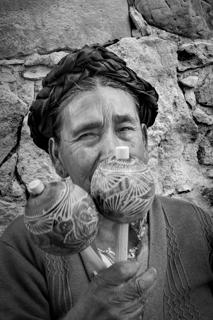 Woman healer with gourd maracas