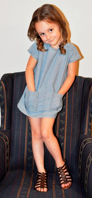 BRAELYN POSES ON A CHAIR FOR FLARE.