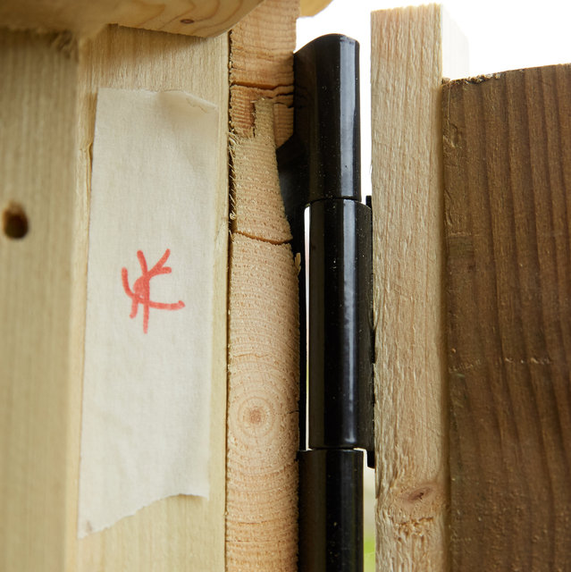 Cracks in the wood where the hinges have been screwed in - shown to inspector on April 24th
