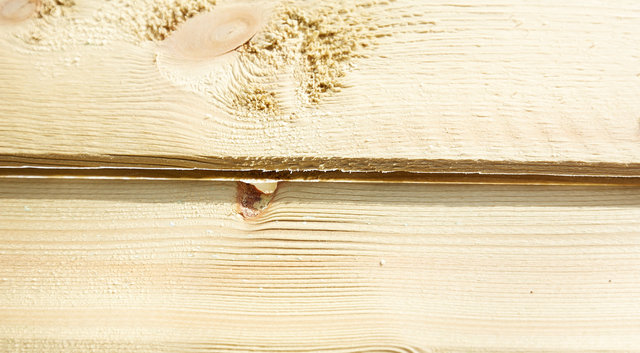 Photo showing gap in tongue and groove of back panel of shed