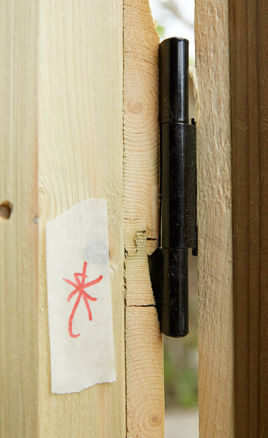 Cracks in the wood where the hinges have been screwed in - shown to inspector on April 24th