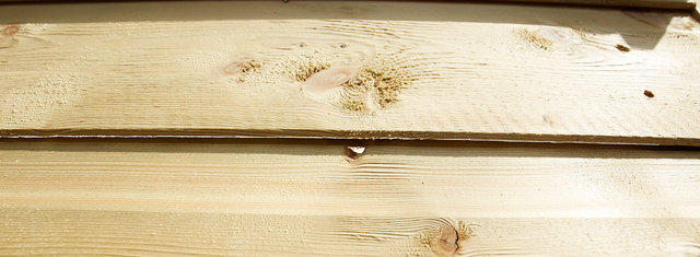 Photo showing gap in tongue and groove of back panel of shed