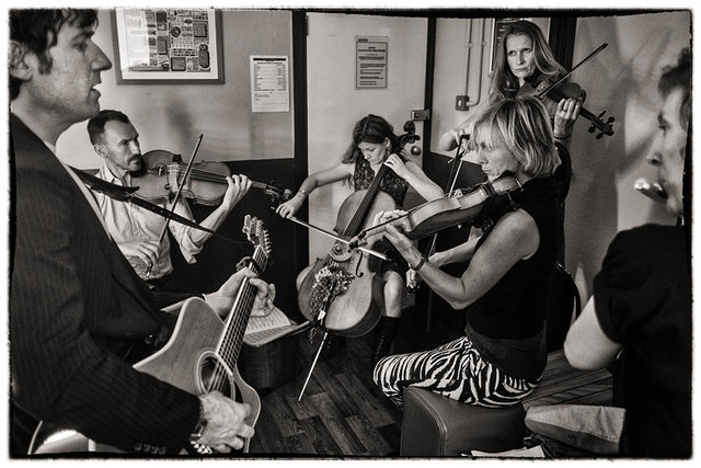 rehearsing acoustic set in changing room