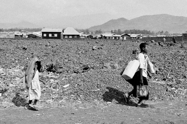 Two girls walking on the lava in Goma