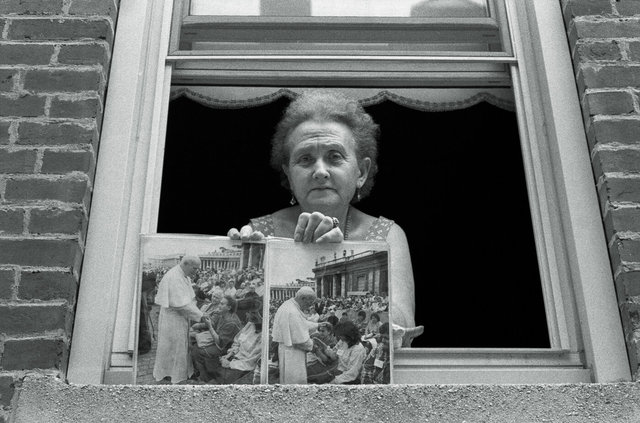 Woman in window with Pope's picture Madonna Della Carva  #12 Aug 10, 1988.jpg