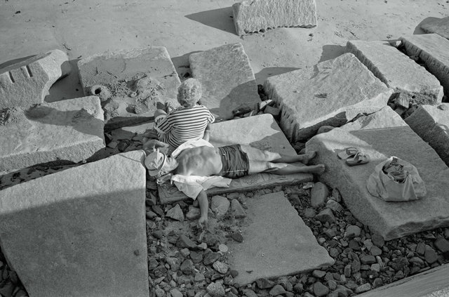 Hampton Beach NH  man sleeping on rocks.jpg