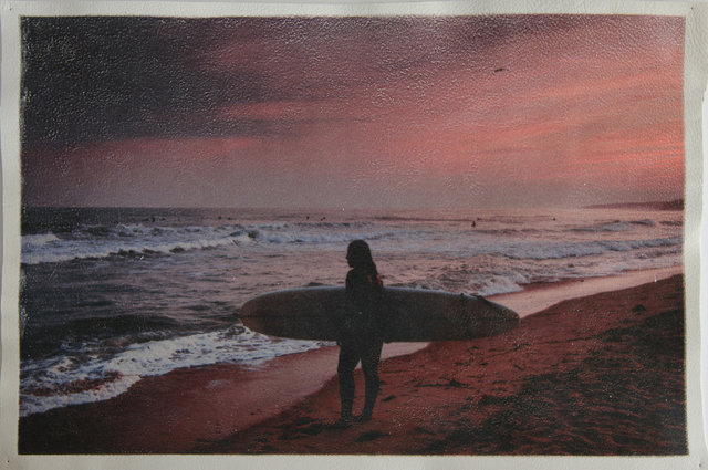 Katrina del Mar Surfergirl watching surfers Ditch Plains Twilight archival pigment print on white leather 12 x 18 in.