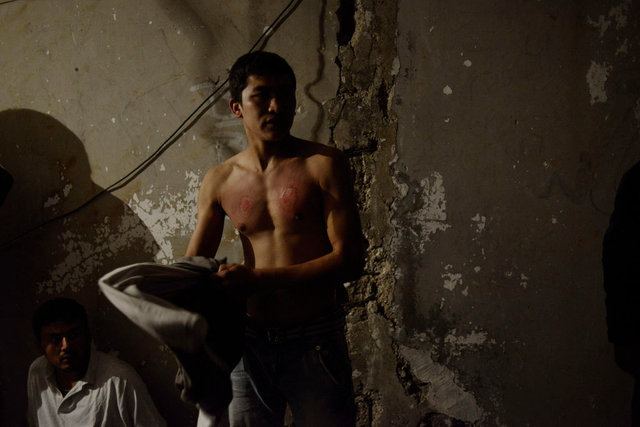 Mahdi Mohseni, 17, wears his chest after he mourns for the Day of Ashura. He has slashed his chest w