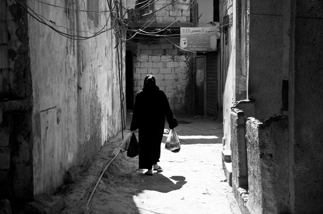 A woman in an alley in Chatila