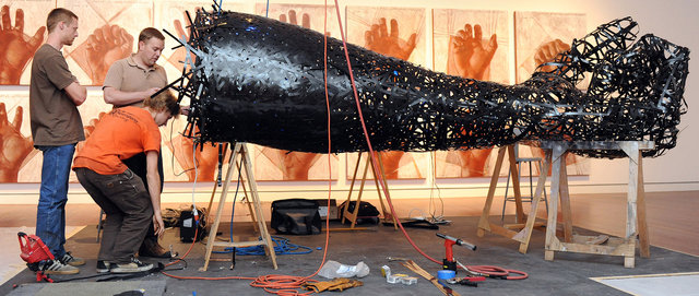 Assistants installing "Open Hand"
