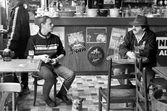 Two men and a dog at a Brussels cafe