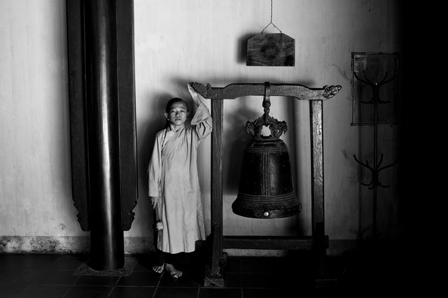 Young Budhist monk with the bell