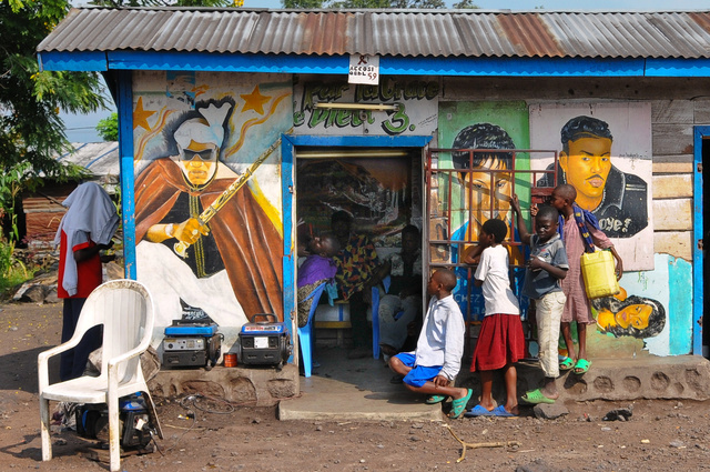 Watching the barber at work in Goma