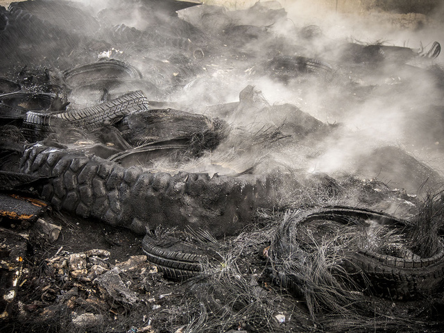 21.Piles of burnt truck tires.